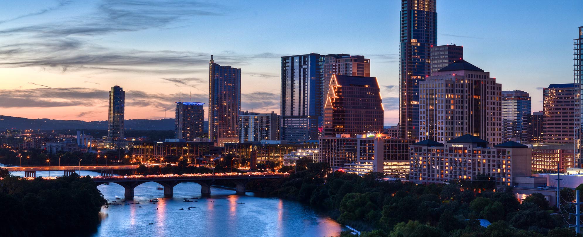 The city skyline of Austin, Texas, lit up at sunset.