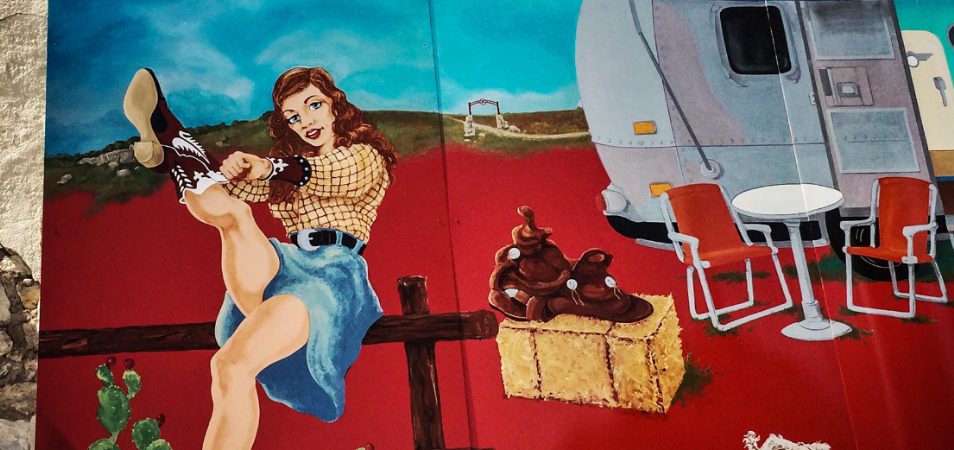 A painting of a smiling woman and a metal trailer in Austin, Texas.