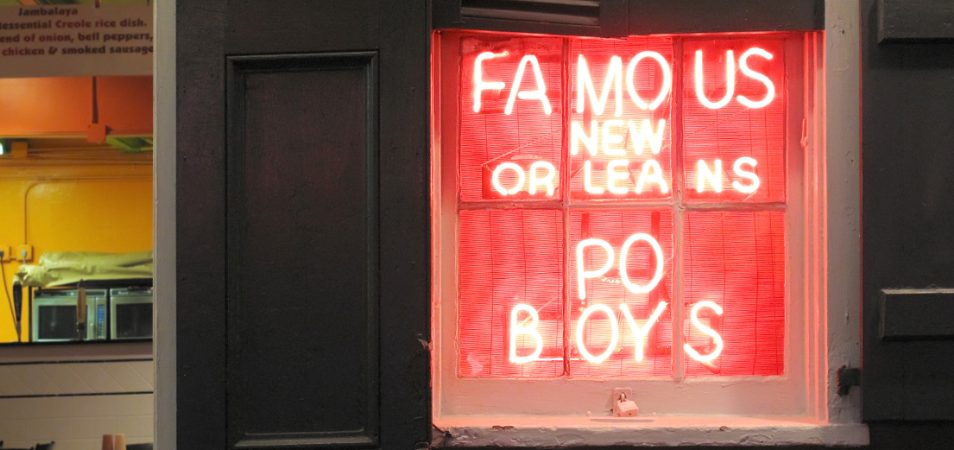 A neon sign that reads "famous New Orleans Po Boys."