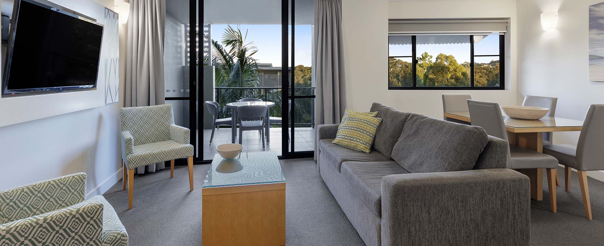 The living and dining area in a 1-bedroom suite at Club Wyndham Coffs Harbor.