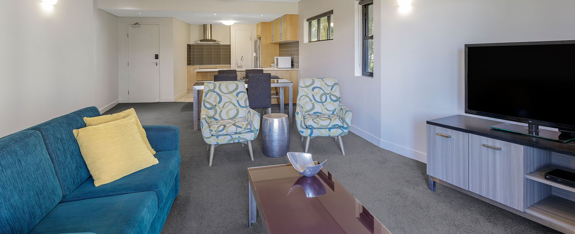 The living and dining area in a 2-bedroom grand suite at Club Wyndham Coffs Harbor.