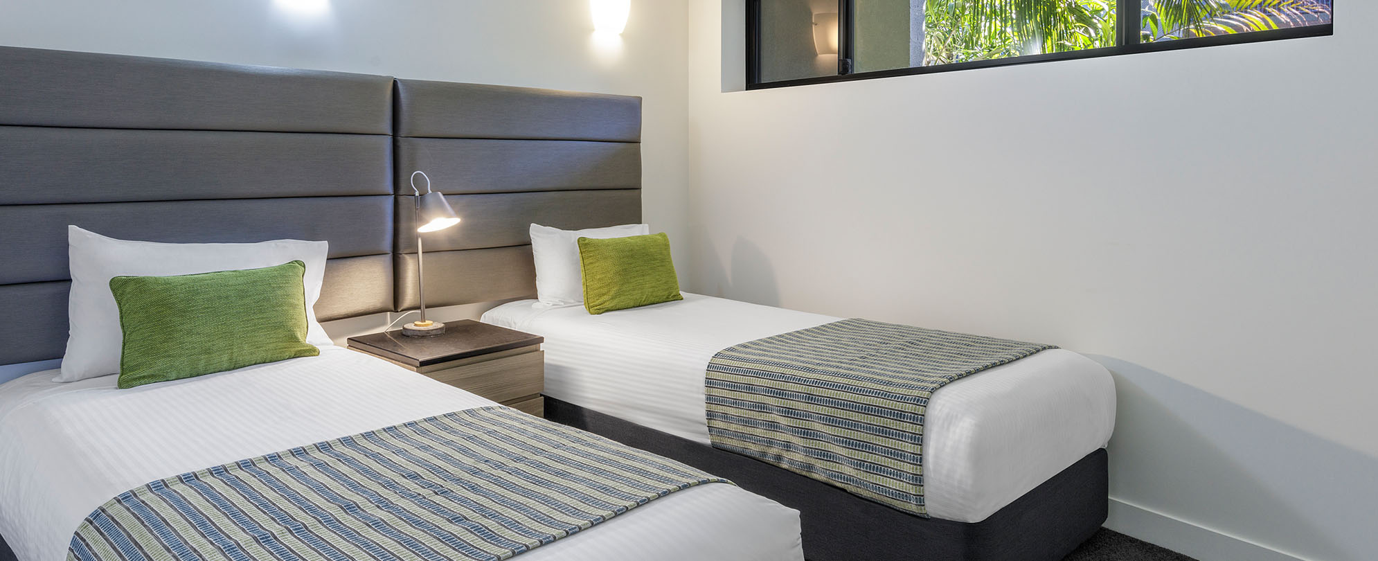 Two twin-sized beds in one of the rooms of a 2-bedroom grand suite at Club Wyndham Coffs Harbor.