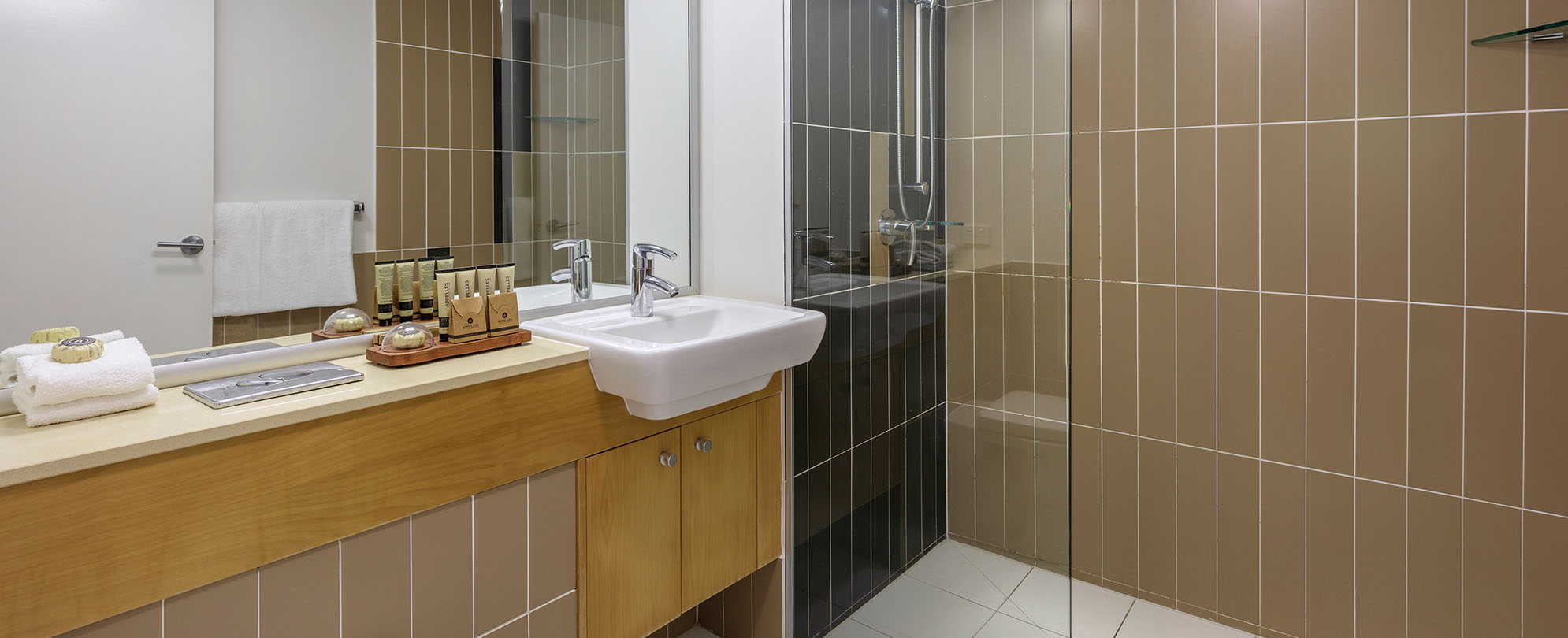 The vanity, sink, and walk-in shower in the 2-bedroom grand suite at Club Wyndham Coffs Harbor.