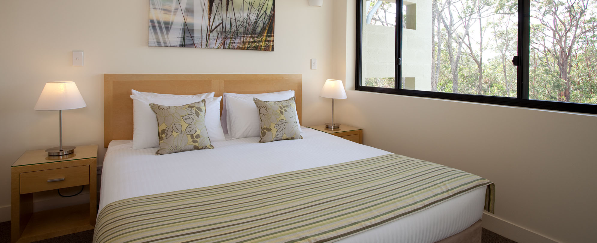 A queen-sized bed in a 2-bedroom suite at Club Wyndham Coffs Harbor.