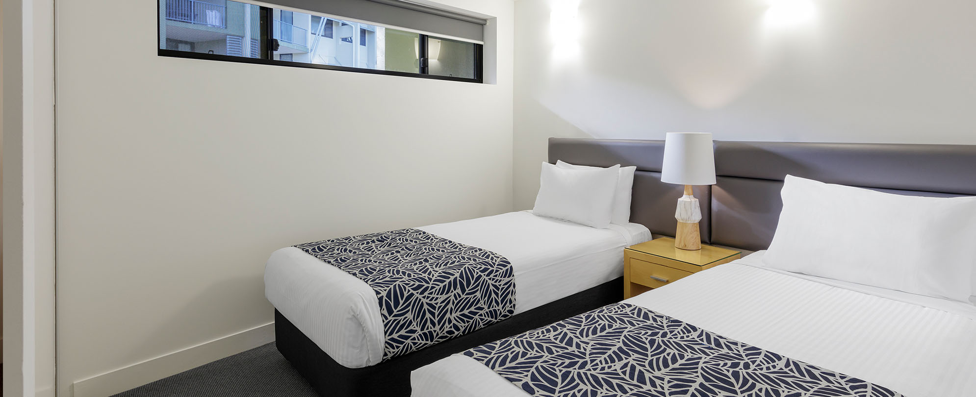 Two twin sized beds in one of the bedrooms of a 2-bedroom suite at Club Wyndham Coffs Harbor.