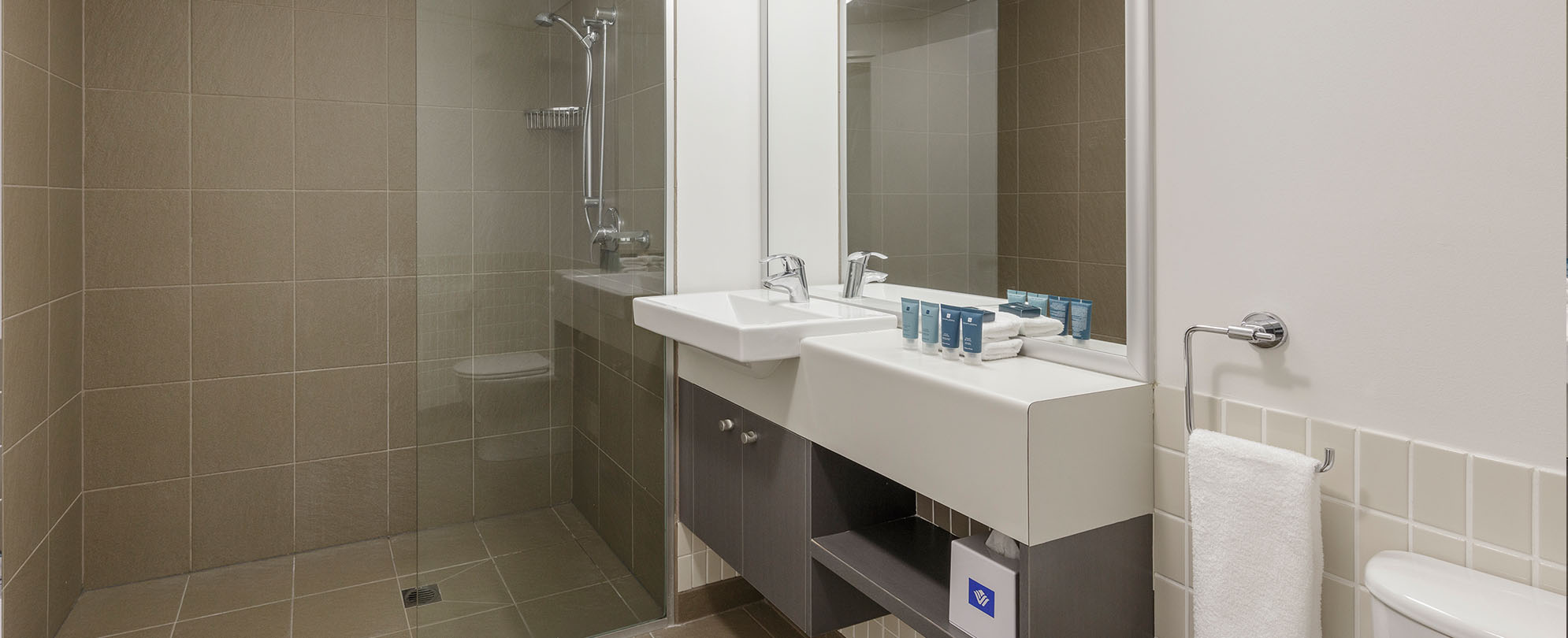 The bathroom with a walk-in shower in a 2-bedroom suite at Club Wyndham Coffs Harbor.