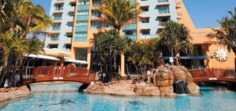 An outdoor pool with two bridges at Club Wyndham Crown Towers, a timeshare resort in Surfers Paradise, Queensland.