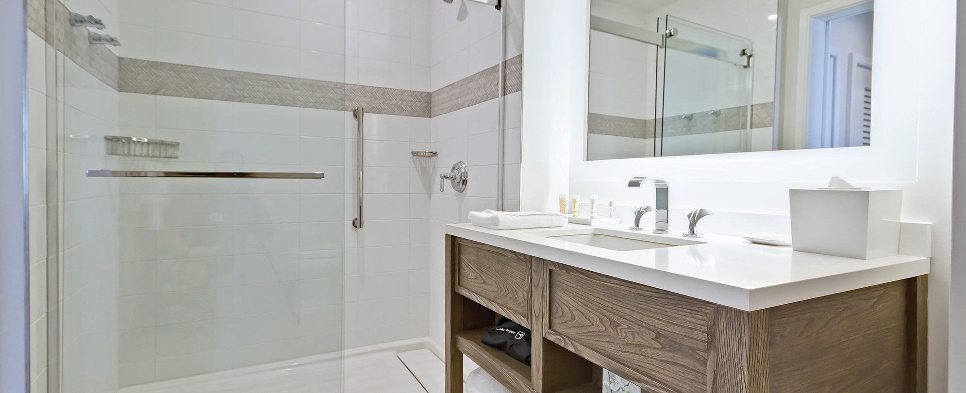 Sink vanity and shower with glass door in a suite bathroom at Margaritaville Vacation Club by Wyndham - Rio Mar.