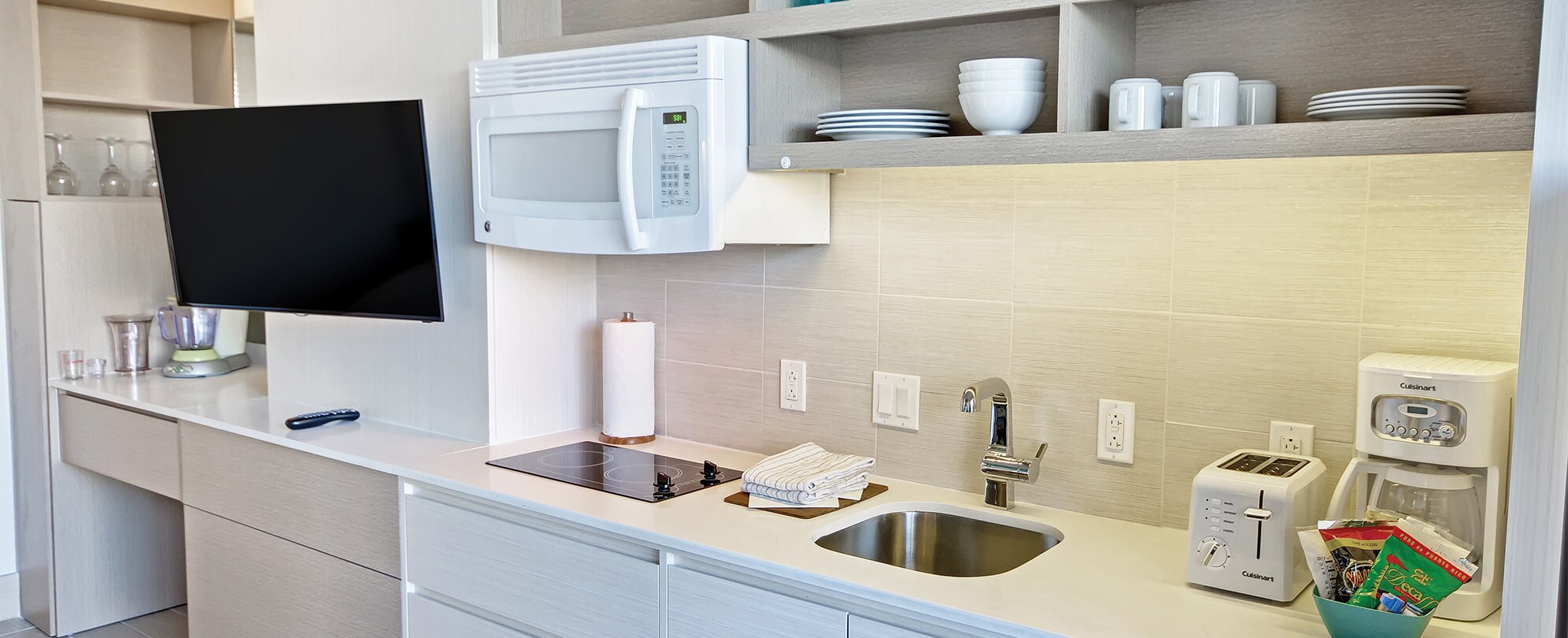 TV, microwave, sink, toaster, and coffee maker in a studio suite at Margaritaville Vacation Club by Wyndham - Rio Mar.