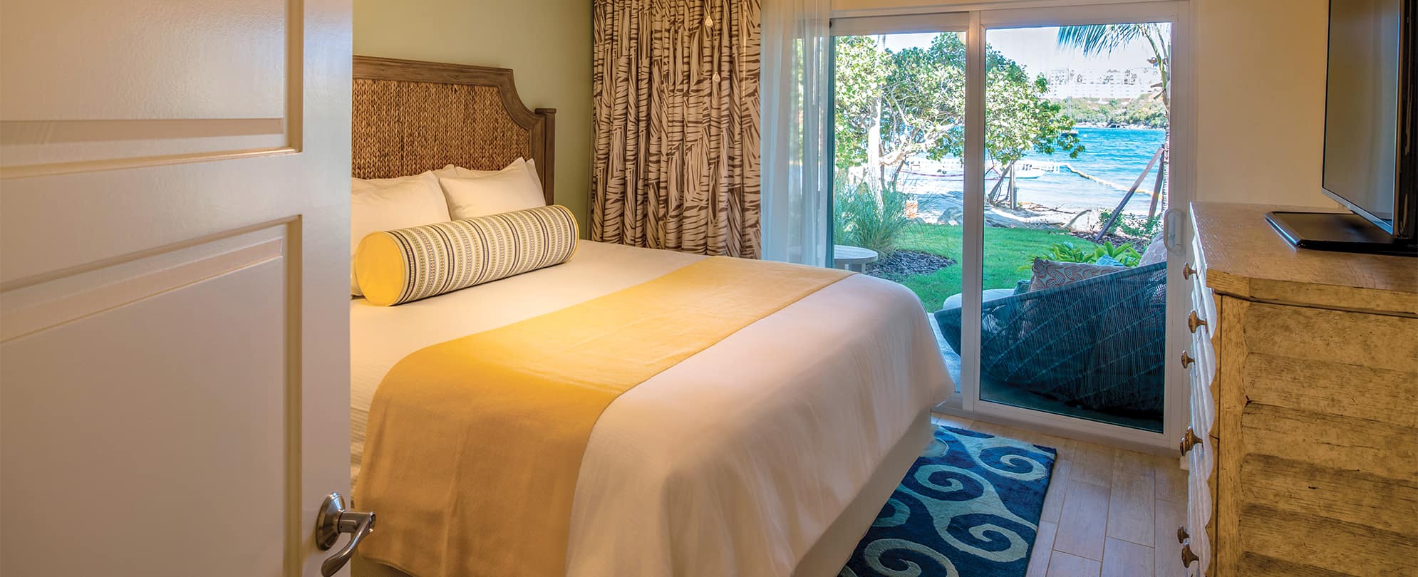 First floor Presidential Reserve bedroom with king bed and ocean view at Margaritaville Vacation Club by Wyndham - St. Thomas.
