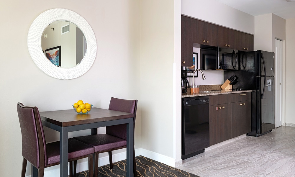 A dining and kitchen area of a studio suite at Worldmark Anaheim.