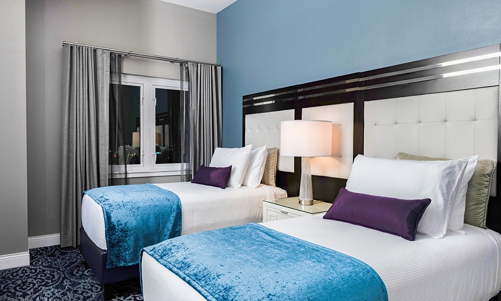 A bedroom, with two twin beds, in a Presidential Reserve suite at Worldmark Anaheim.