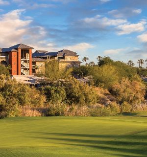 The green of a golf course, with Club Wyndham and WorldMark Indio timeshare resort in the distance.