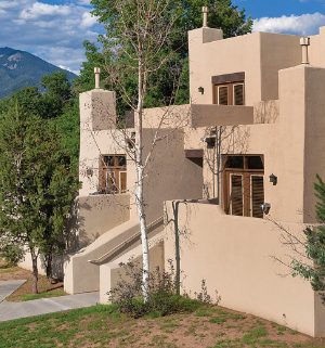 The exterior of Club Wyndham Taos, a timeshare resort in Taos, New Mexico, surrounded by trees and mountains.