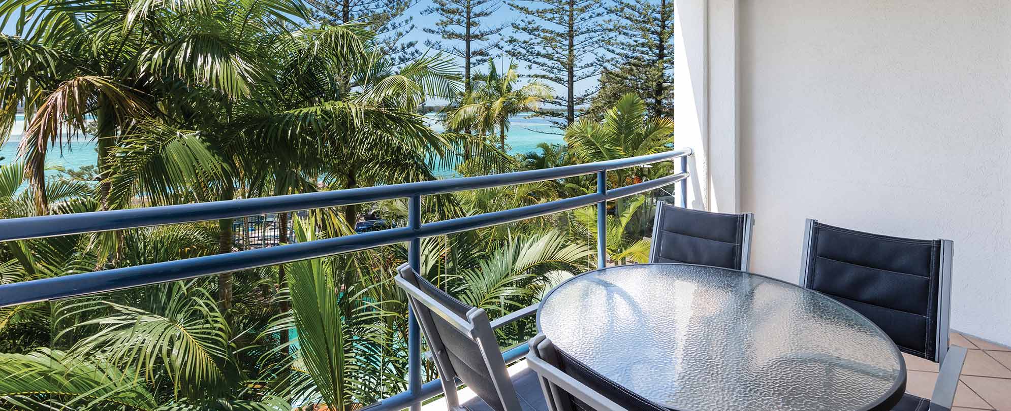 A balcony with a table and chairs in a 2-bedroom suite at Club Wyndham Golden Beach. 