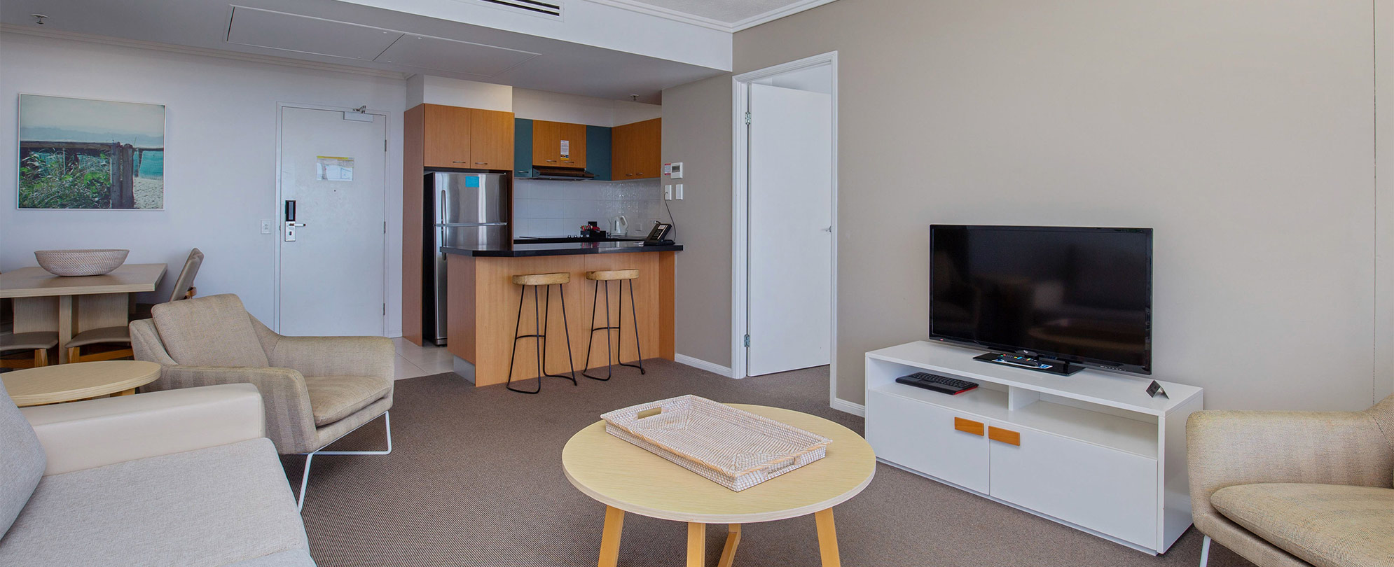 The living area of a Club Wyndham Kirra Beach standard suite connected to the kitchen and a bedroom.