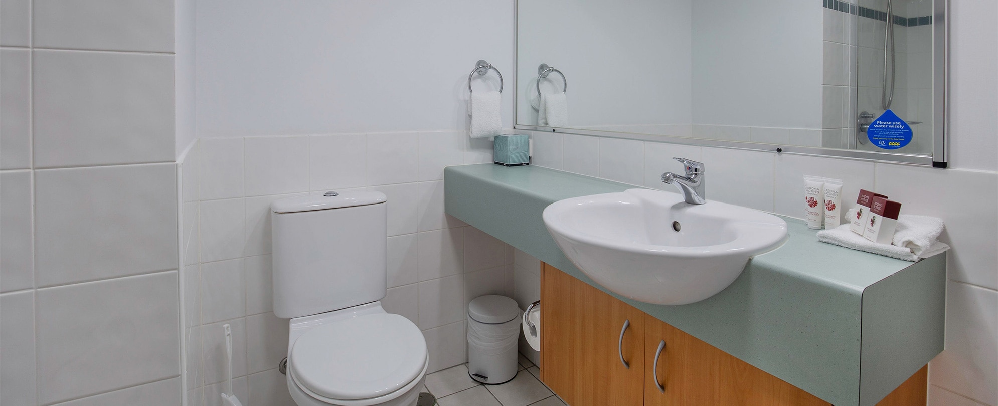 The toilet and vanity sink in the bathroom of a Club Wyndham Kirra Beach standard suite.