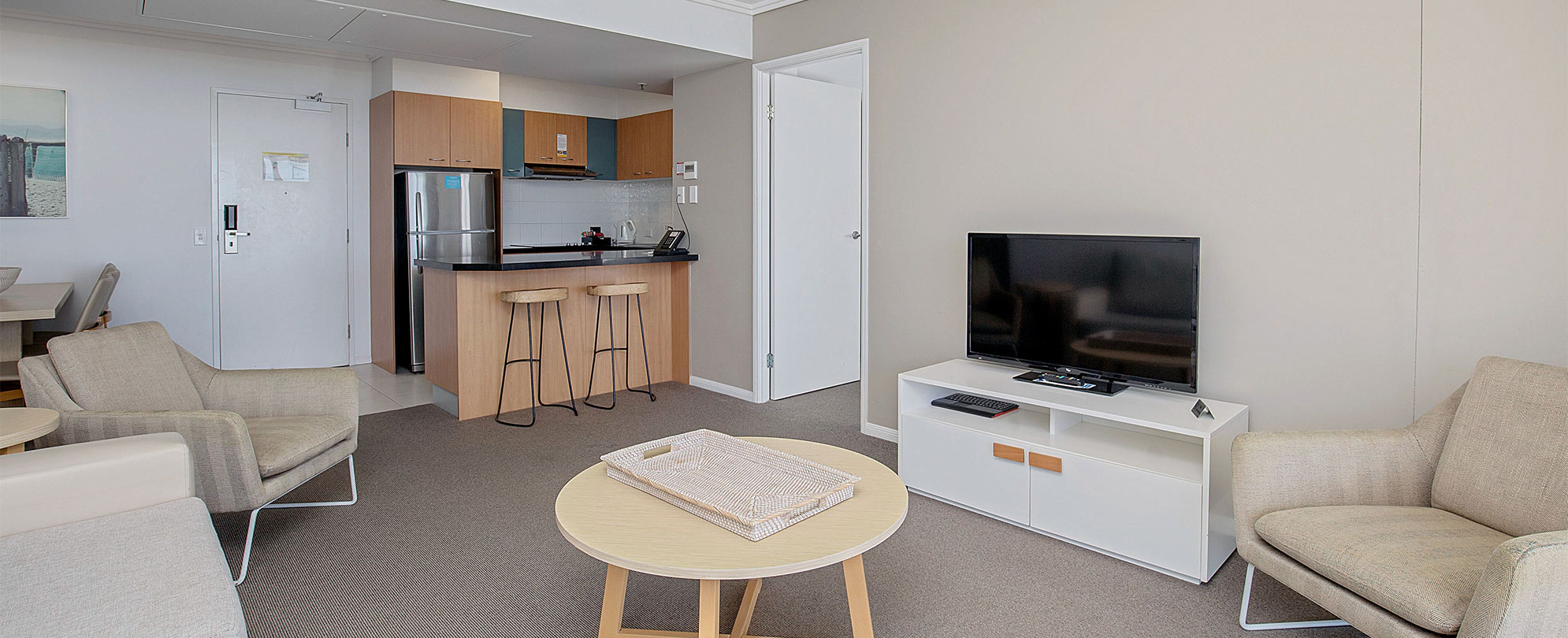 The living area and kitchen of a Club Wyndham Kirra Beach standard suite.