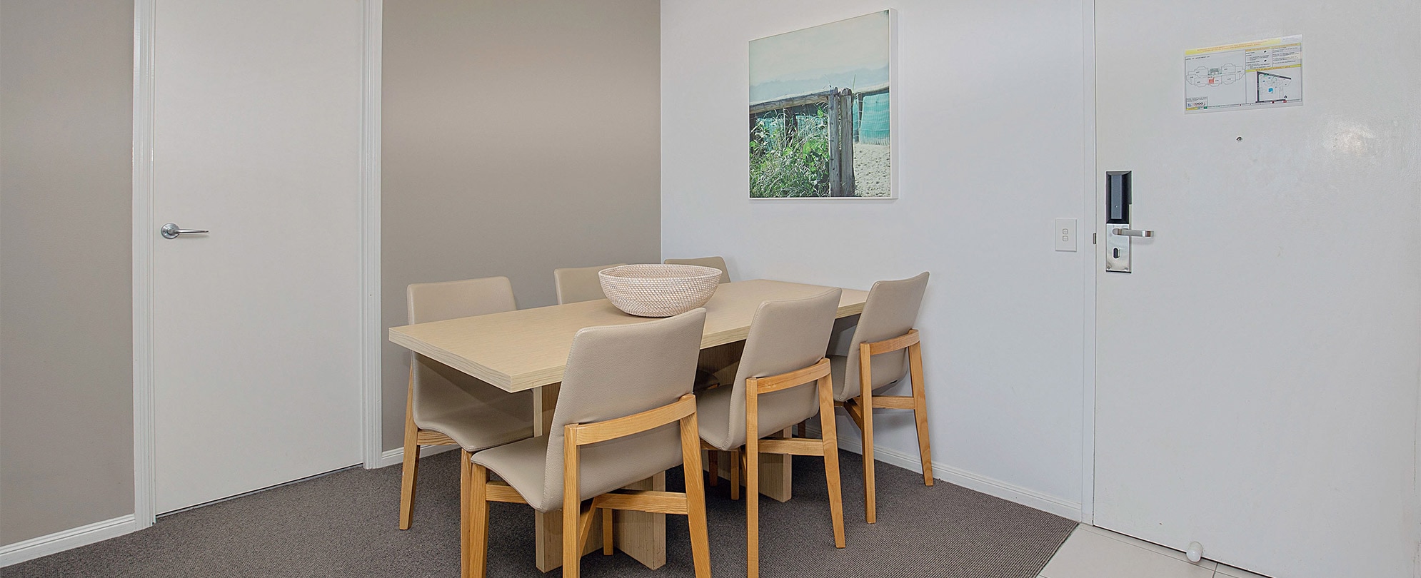 The dining table with 6 chairs in a Club Wyndham Kirra Beach standard suite.