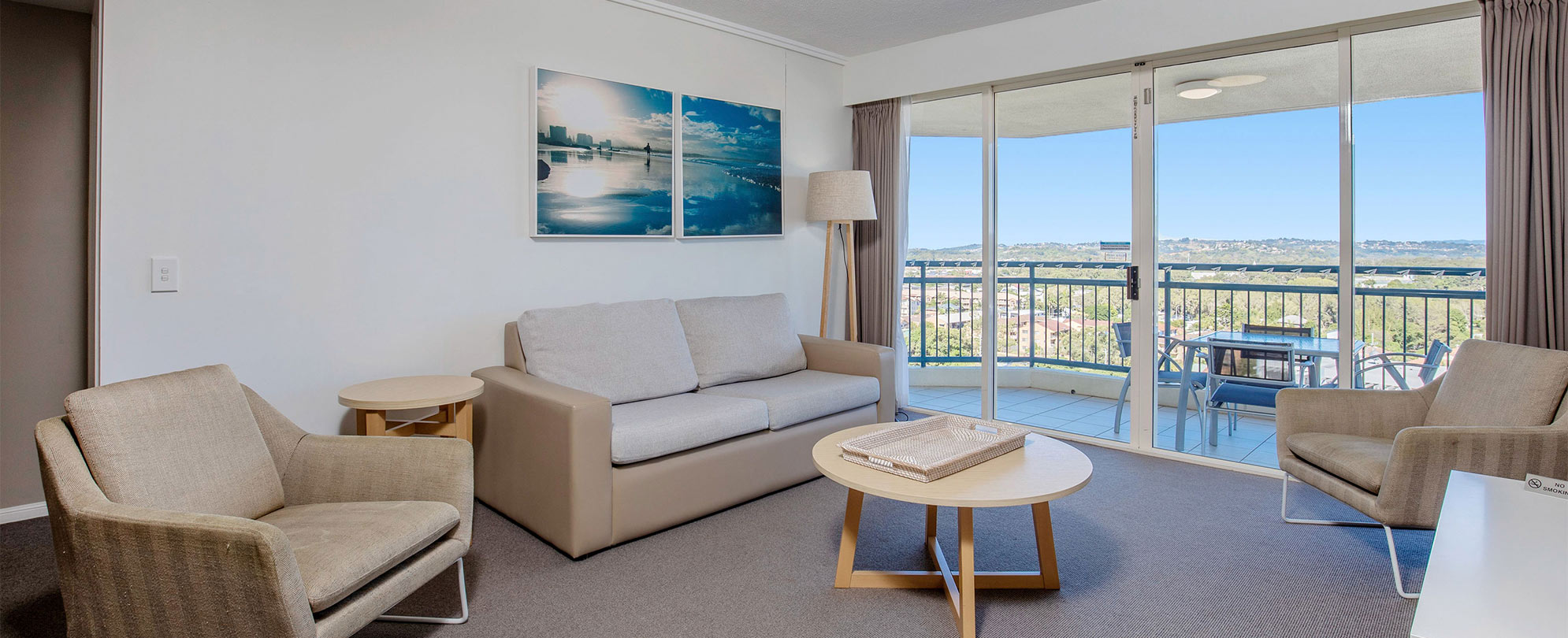 The living area of a Club Wyndham Kirra Beach standard suite with a couch, chairs, and coffee table.