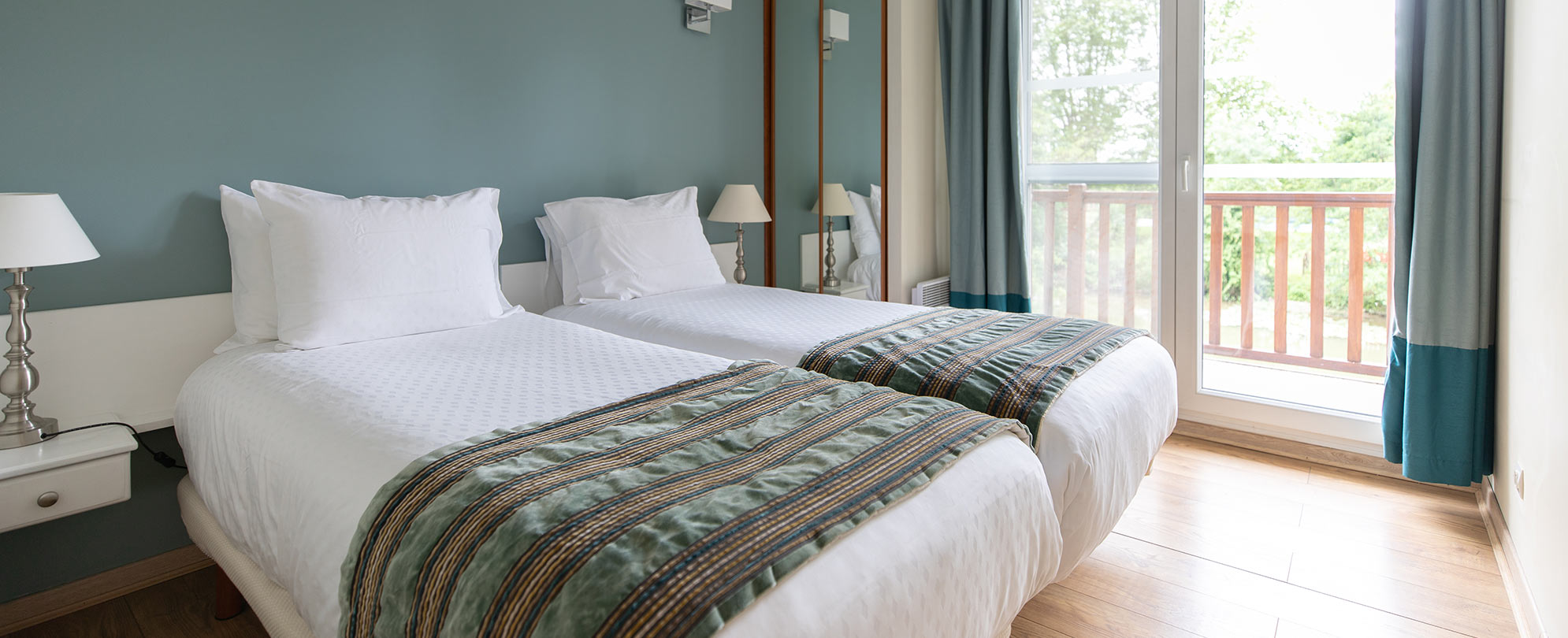 Double twin-sized beds in the second bedroom of a 2-bedroom suite at Club Wyndham Normandy.