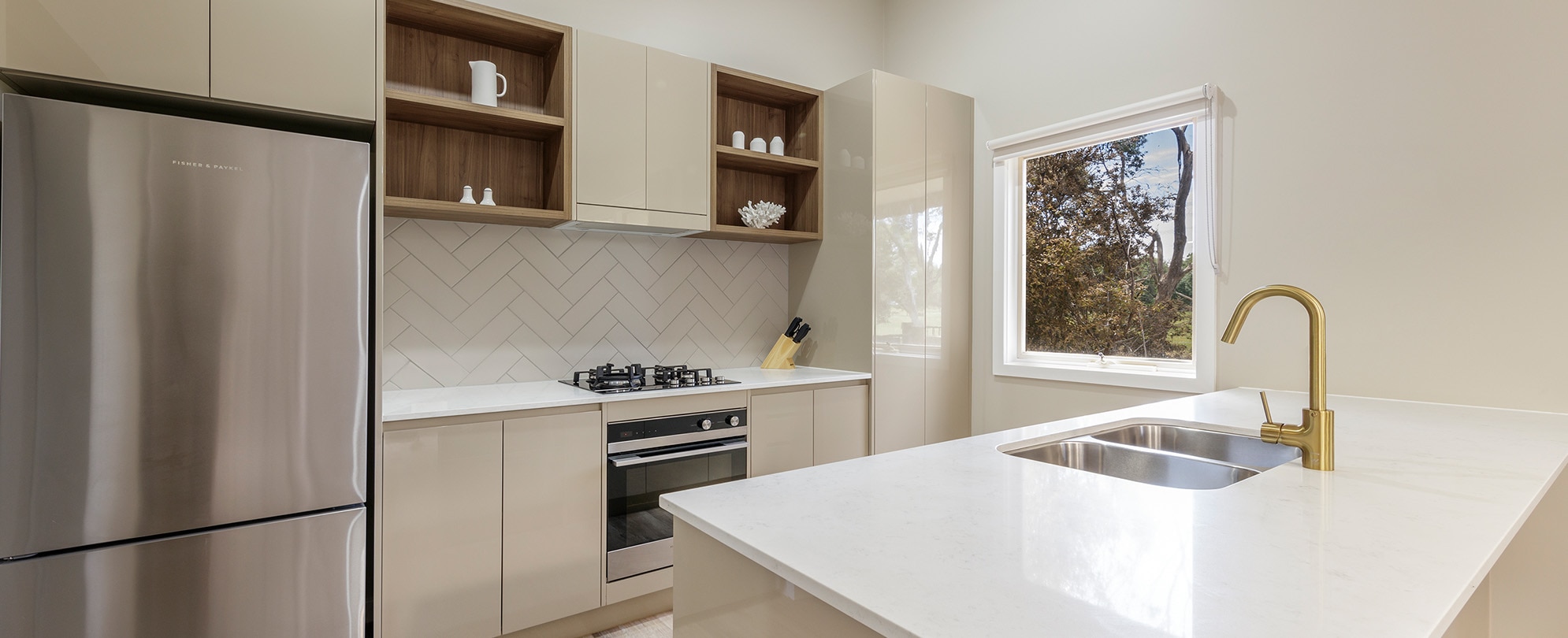 The kitchen with a full fridge, stove, oven, and sink in a Club Wyndham Phillip Island 3-bedroom suite.