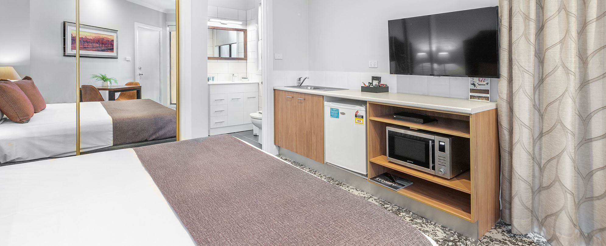 A Club Wyndham Pokolbin Hill studio suite with a bed, flat screen TV, microwave, mini fridge, sink, closet, and bathroom.