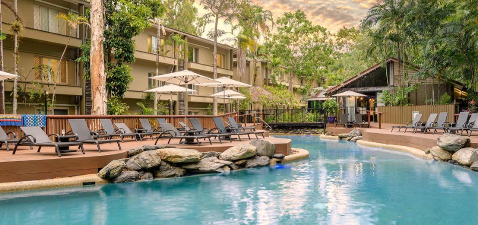 The outdoor resort pool surrounded by large rocks and pool loungers at Club Wyndham Port Douglas in Queensland, Australia.