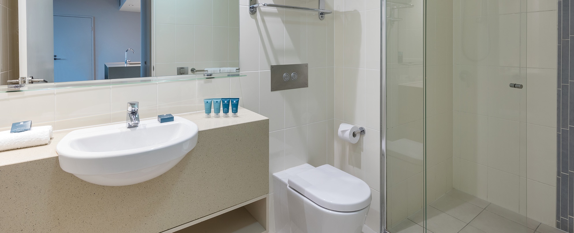A bathroom with a walk-in shower in a 1-bedroom suite at Club Wyndham Surfers Paradise.