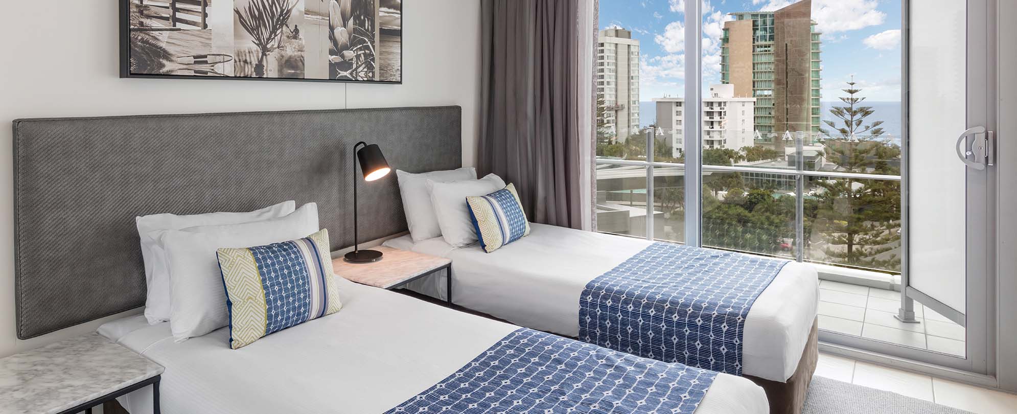 A second bedroom with two twin-sized beds in a 2-bedroom suite at Club Wyndham Surfers Paradise.