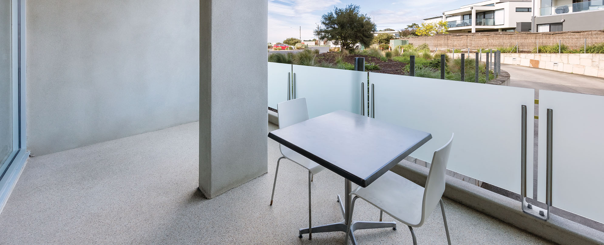 A balcony with a table in chairs from an accessible suite at Club Wyndham Torquay.