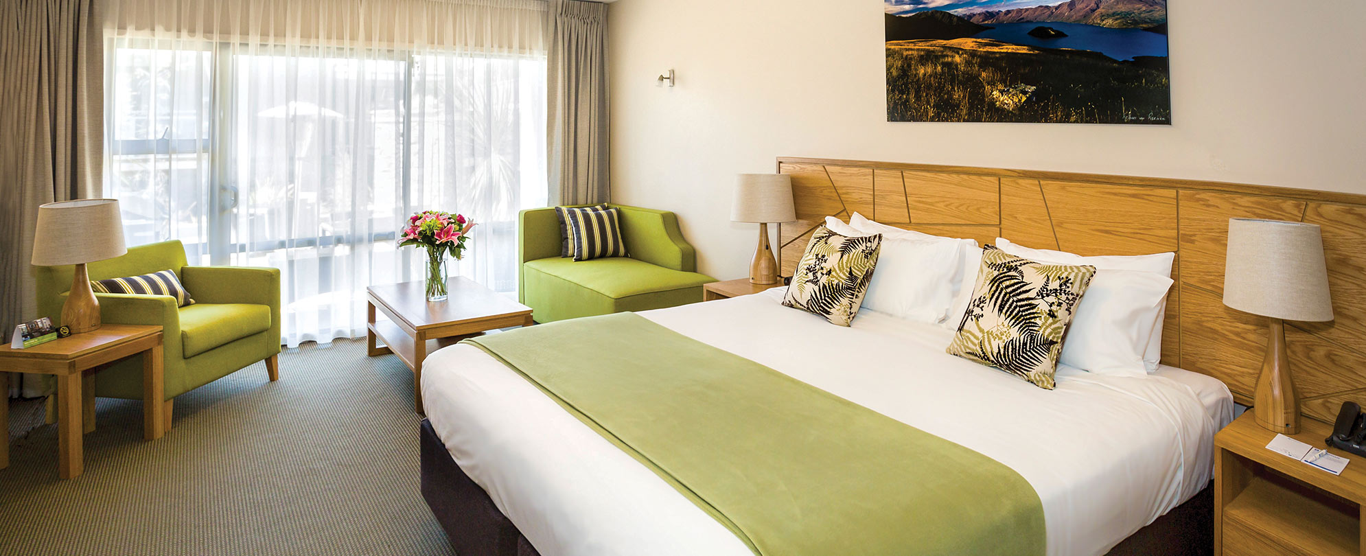 A king-sized bed in the bedroom of the standard suite at Club Wyndham Wanaka.
