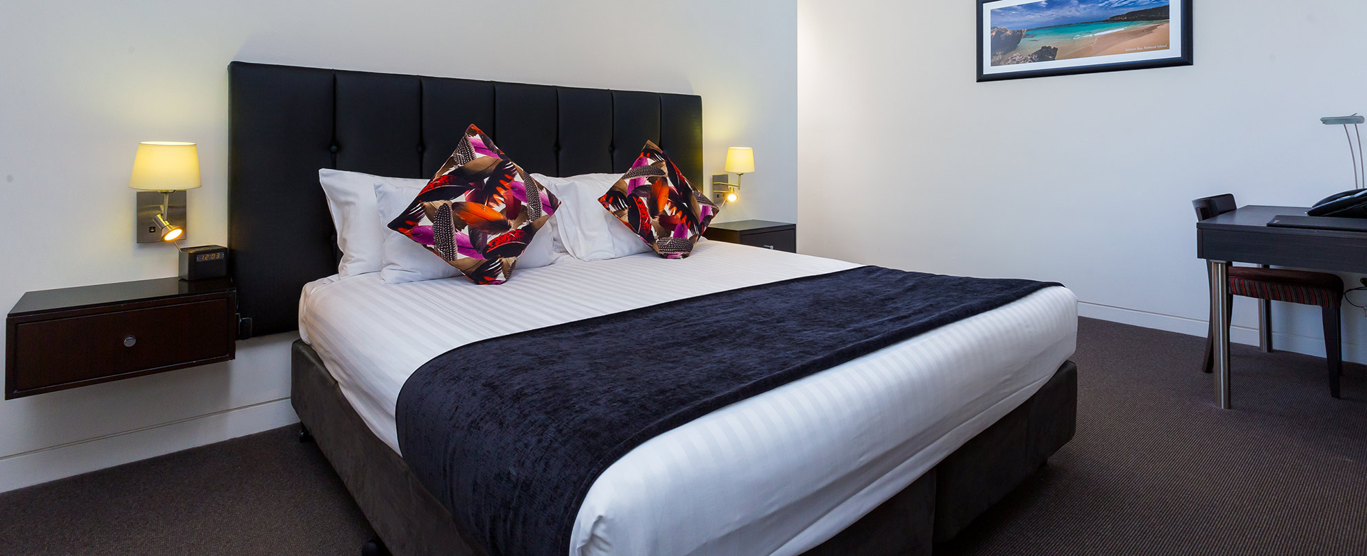 A king bed neatly made inside a studio suite at Club Wyndham Perth.