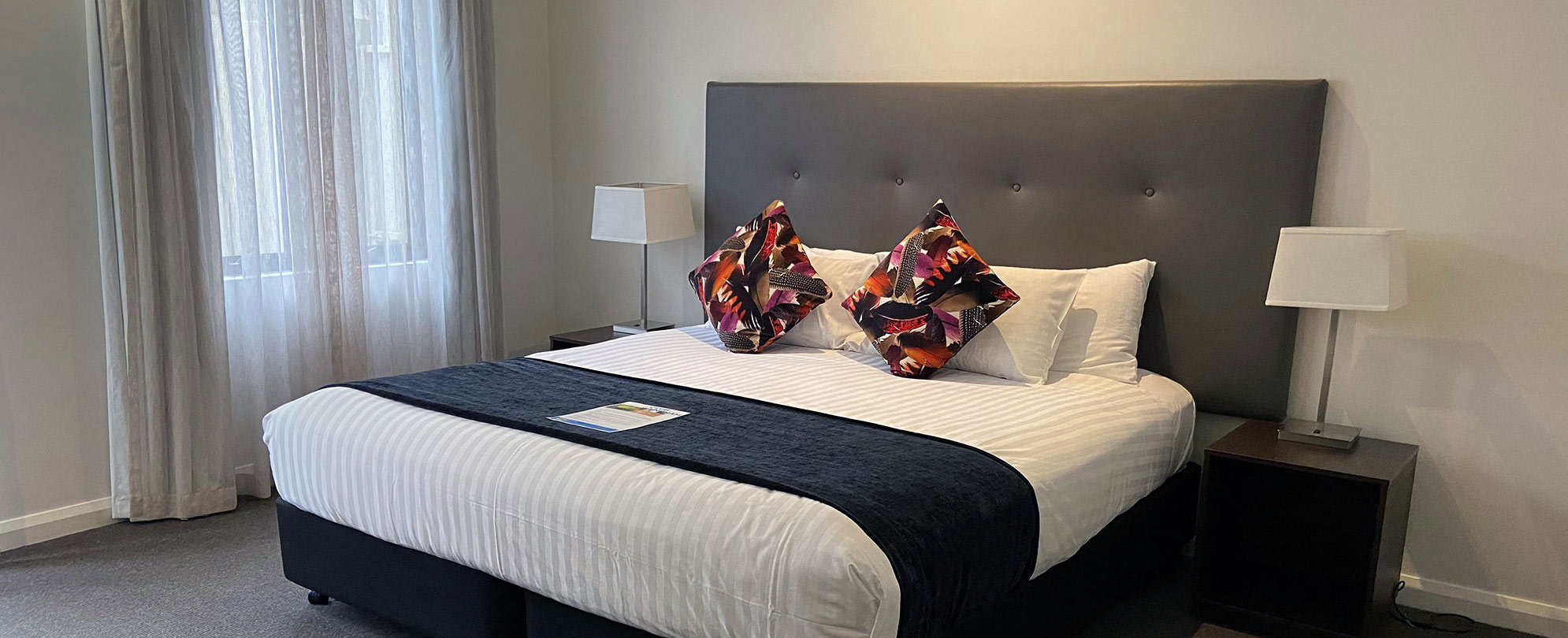A king-sized bed neatly made inside a suite at Club Wyndham Perth.
