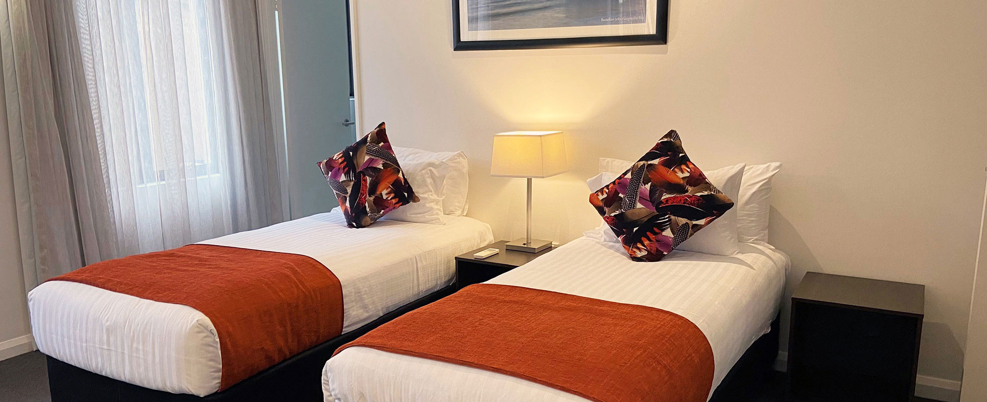 Two twin-sized beds neatly made inside a suite at Club Wyndham Perth.