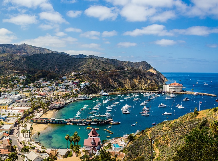 Mountains and a bay with a pier and boats at Catalina Island, a Baja Ensenada cruise port.