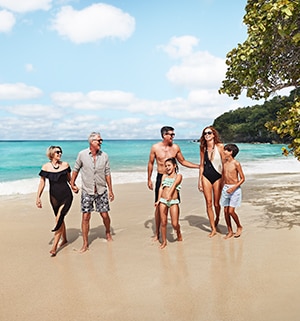 A family of six gathered together on a Caribbean beach, sharing a laugh.