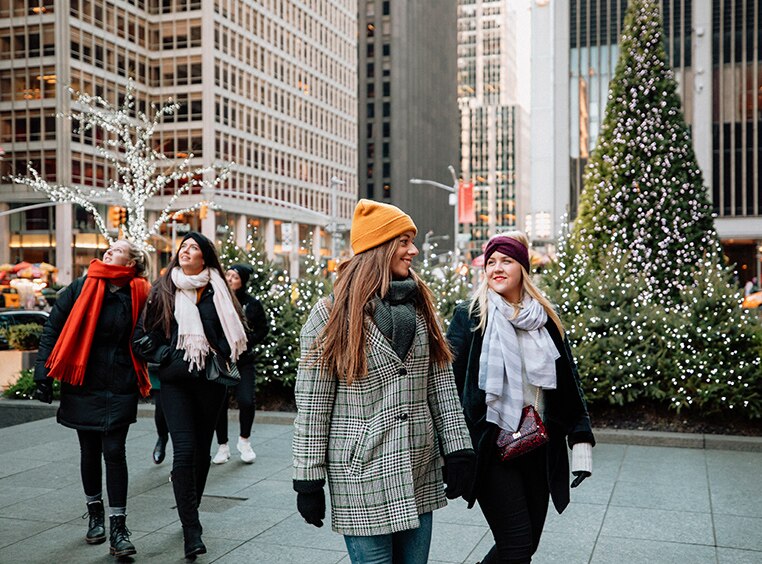 A group of women walking in NYC during the winter.