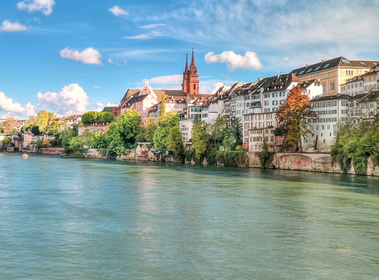 Panoramic view of the Rhine River in Switzerland with residential buildings in the background.