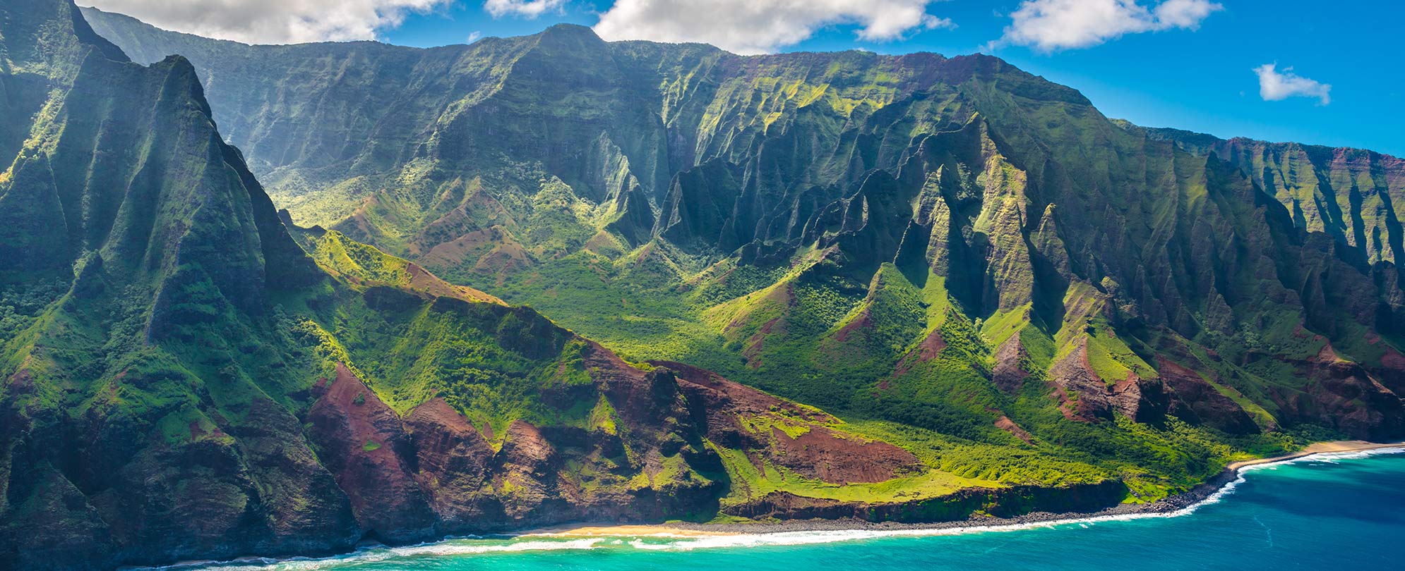 Lush mountain landscape along the coastline with WorldMark by Wyndham Hawaii cruise.