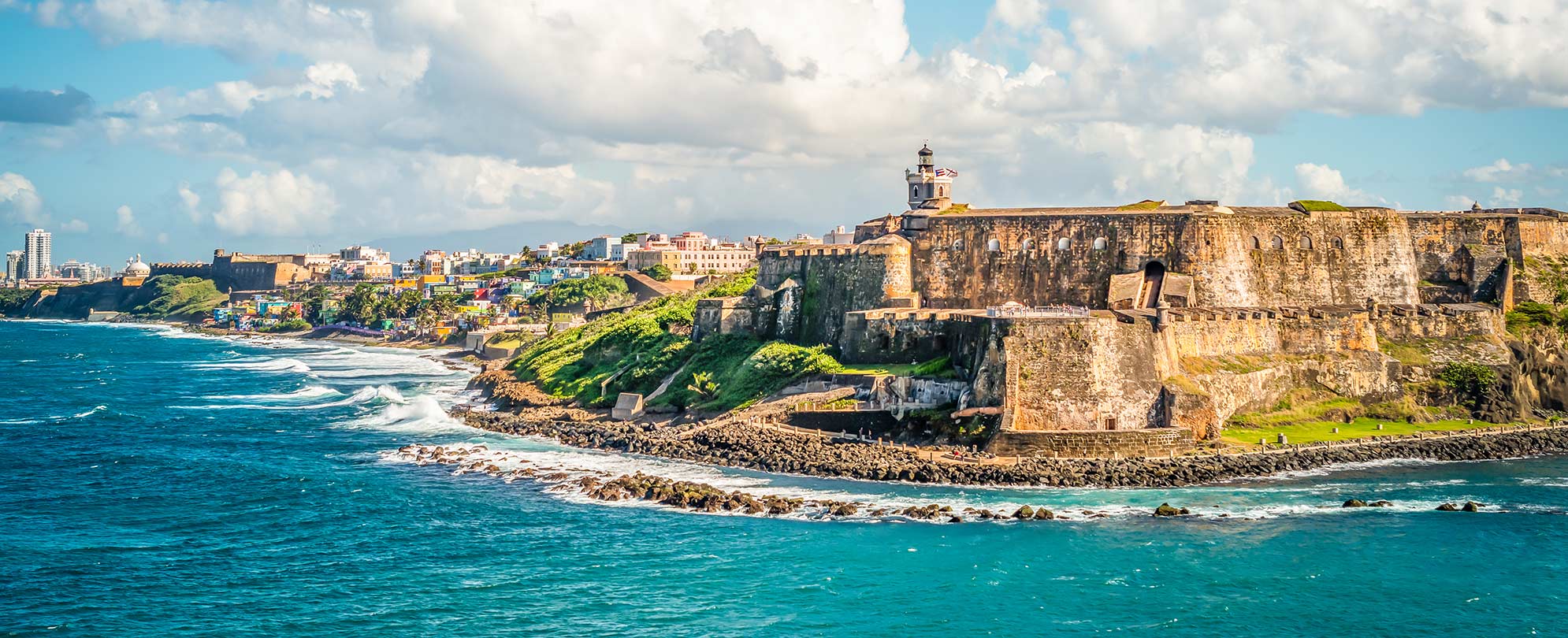 Shoreline by cliff beneath San Felipe Del Morro castle in Old San Juan, Puerto Rico. 