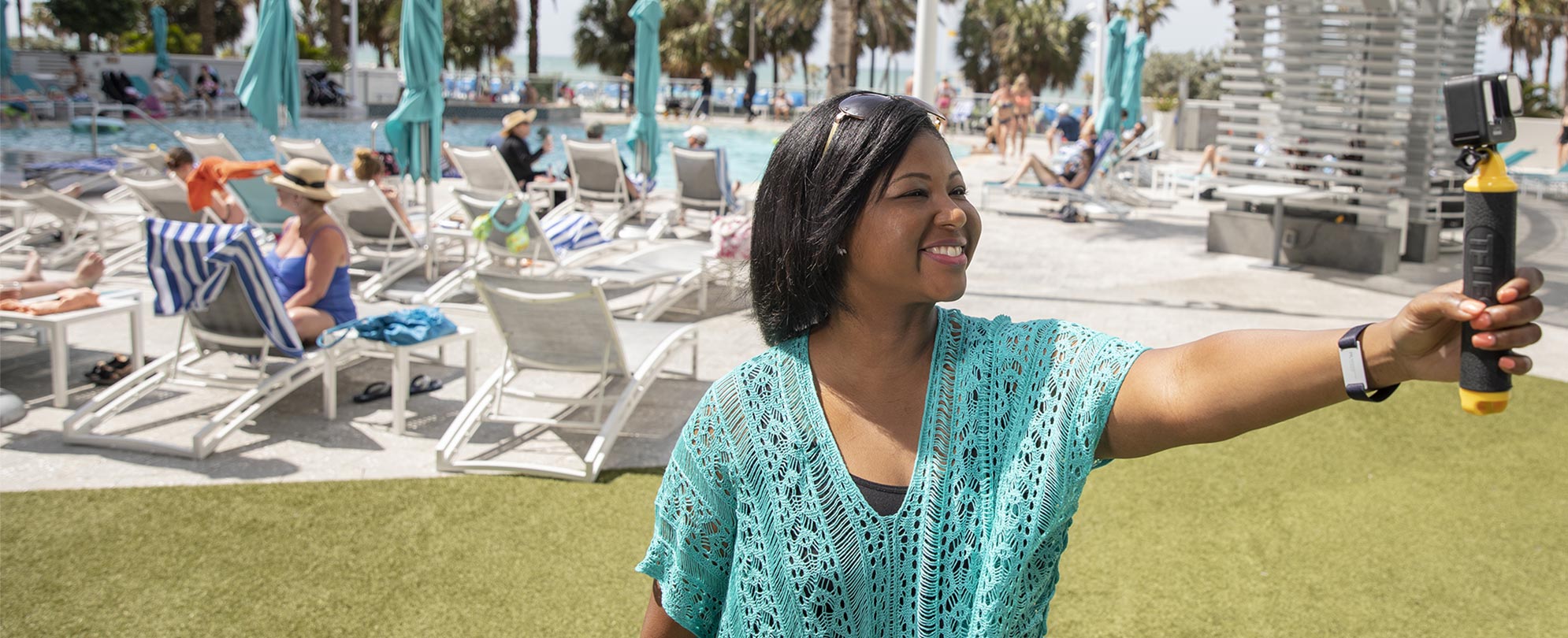 Melody Bostic Brown takes a selfie by a resort pool.