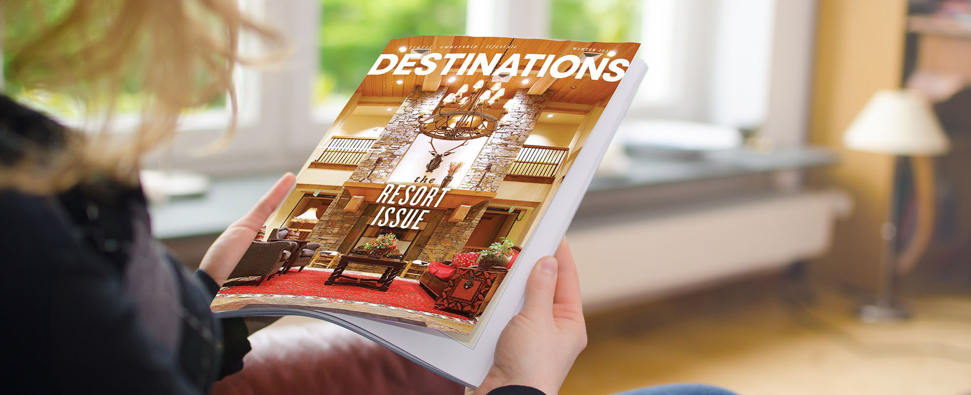 A woman holds a copy of Destinations Magazine, the resort issue.
