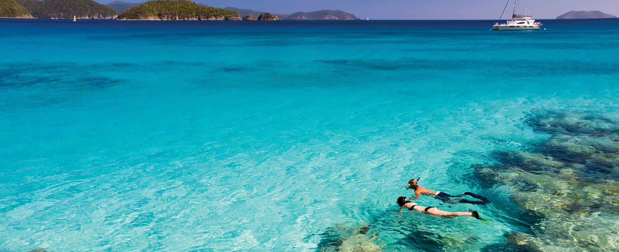 A couple is snorkeling in the Caribbean Sea.
