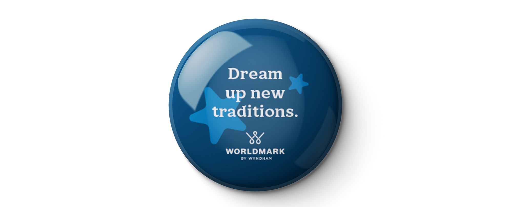 A blue "Dream up new traditions" WorldMark by Wyndham pin