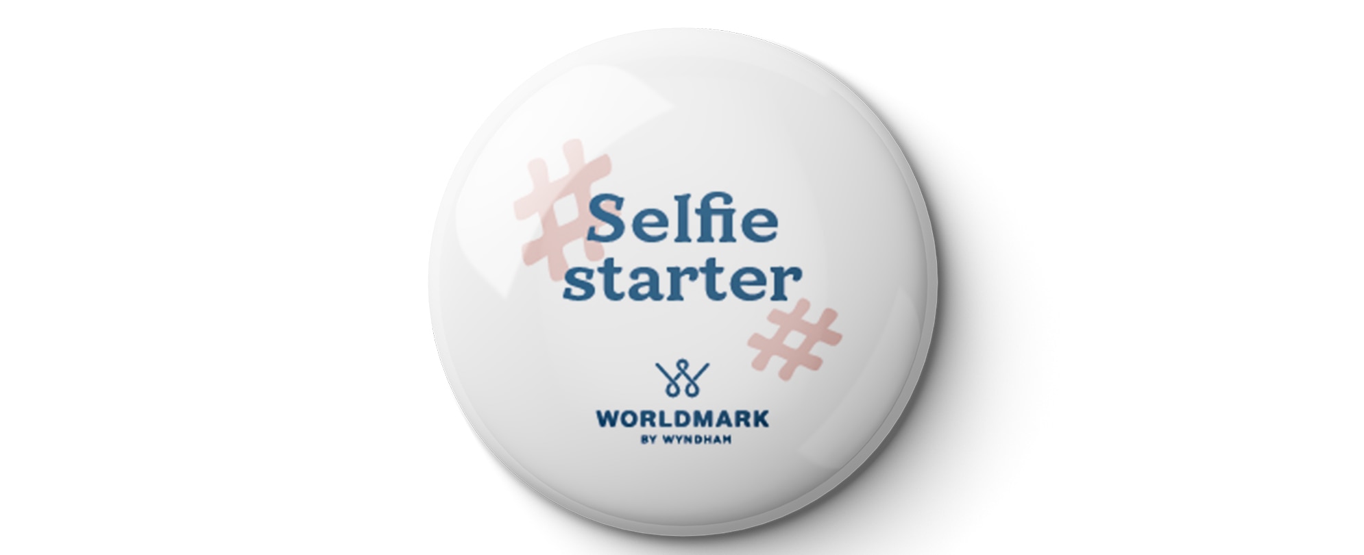 A white "Selfie Starter" WorldMark by Wyndham pin 