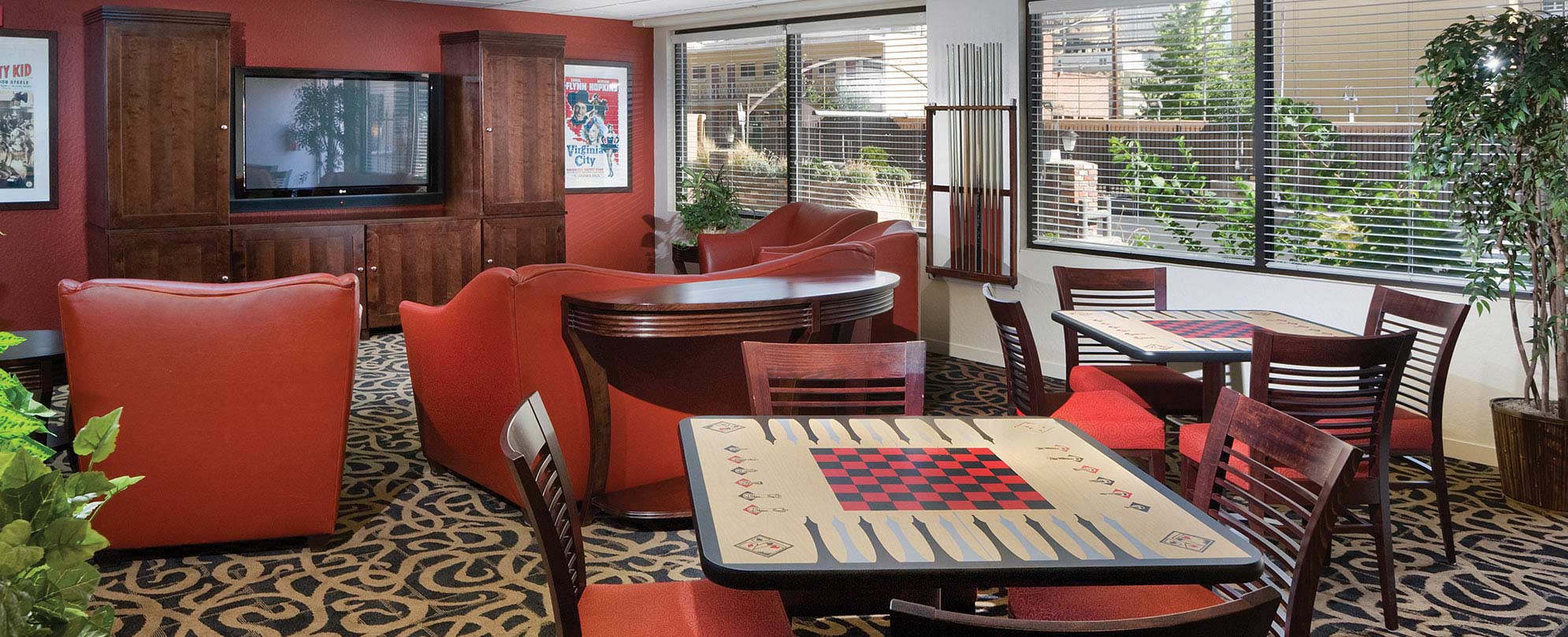 Couches, a television, and wood chairs around checker board tables at WorldMark Reno in Nevada.