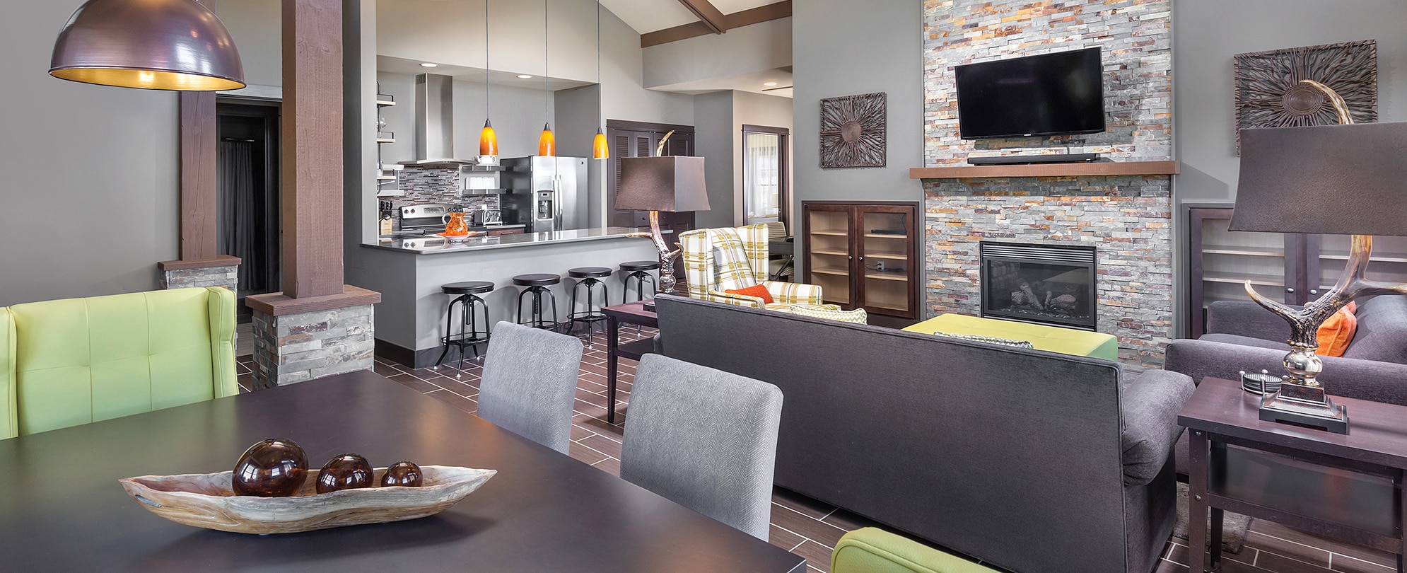 A dining room, living area, and kitchen inside a WorldMark by Wyndham suite.